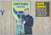  ??  ?? SILVER SERVICE Robinson at least got his hands on the League Cup