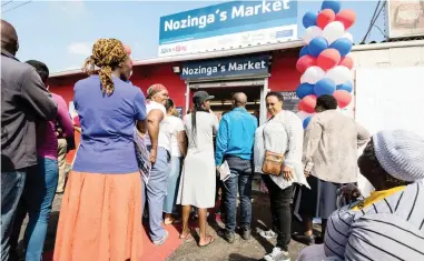  ??  ?? NEW-STYLE MARKET: Customers queue at the opening of Nozinga’s Market in Gugulethu yesterday.