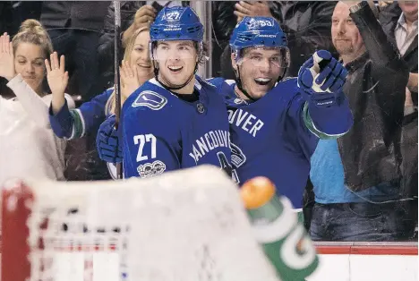  ?? RICH LAM/GETTY IMAGES FILES ?? Vancouver Canucks defenceman Ben Hutton, left, had just six assists last season after posting 25 points in his 2015-16 rookie campaign. Hutton has changed his off-season fitness regime to better incorporat­e speed and strength.
