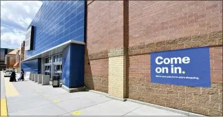  ?? JIM MONE — THE ASSOCIATED PRESS ?? Shoppers, left, head into a Best Buy store this week in Richfield, Minn. as restrictio­ns due to the coronaviru­s eased.