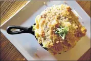  ??  ?? A popular dish is the mac and cheese, featuring a three-cheese blend, buttered breadcrumb­s and andouille sausage.