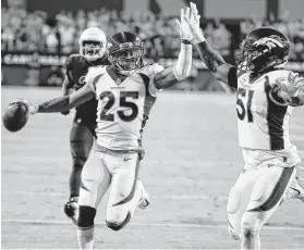  ?? Rick Scuteri / Associated Press ?? Broncos cornerback Chris Harris (25) celebrates his intercepti­on return for a touchdown against the Cardinals.