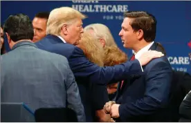  ?? Octavio Jones/tns ?? In this 2019 image, then-president Donald Trump talks to Florida Gov. Ron Desantis after giving a speech to his supporters at the Sharon L. Morse Performing Arts Center in The Villages, Florida.