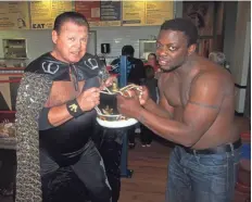  ??  ?? Wrestlers Jerry “The King” Lawler, left, and Derrick King took to the ring at grand opening festivitie­s for King Jerry Lawler’s Memphis BBQ Company.