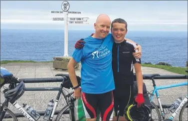  ??  ?? Chris and Cameron Johnson arrive at Land’s End after their 1,300-mile ride