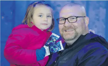  ??  ?? Jeff Hynes takes his daughter Harlow, 5, to her first Canucks game Thursday and hopes to continue doing so on a regular basis as a bonding experience.