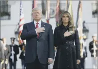  ??  ?? President Donald Trump and first lady Melania Trump stand in silence to mark the September 11 anniversar­y.