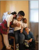  ??  ?? “I have to be extremely strong for my kids and some days I can’t even be strong for myself,” says Tiffany Porter, 32, shown with her children Dec. 23 in their home in Washington, D.C.