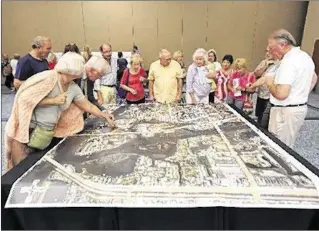  ?? DAMON HIGGINS / THE PALM BEACH POST ?? Jupiter residents and town officials gather at the Community Center to look over plans for Inlet Village. Growth and the future of Jupiter are top issues for council candidates.
