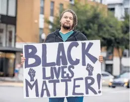  ?? PATRICK CONNOLLY/ORLANDO SENTINEL ?? Zach, who declined to give his last name, joined a small group of activists on the corner of Orange Avenue and State Road 50 in Orlando on Thursday.