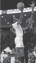  ?? Godofredo A. Vasquez / Staff ?? When UH guard DeJon Jarreau goes up for a layup, he takes with him inscriptio­ns on his shoes paying tribute to his grandmothe­r and cousin, who both died in October.