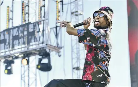  ?? Scott Dudelson Getty Images ?? PnB ROCK, shown performing in 2019, had been warned about the dangers of exposing informatio­n on social media, his attorney said.