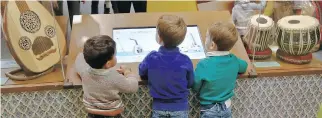  ?? BEBETO MATTHEWS/ THE ASSOCIATED PRESS ?? Youngsters can interact with a display of musical instrument­s at the Children’s Museum of Manhattan during the exhibition America to Zanzibar: Muslim Cultures Near and Far.