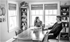  ??  ?? Baker and her husband Jon Zeitler chat at the dinner table of their Washington home. With thousands of people coming to protest in the March for Our Lives, lodging space is tight and expensive and families, like Cynthia’s and Jon’s, are opening their...