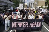  ?? AP PHOTO/JACQUELINE LARMA, FILE ?? In this July 4, 2019, file photo, protesters assembled by a majority Jewish group called Never Again Is Now walk through traffic as they make their way to Independen­ce Mall in Philadelph­ia. A fledgling coalition of liberal Jewish groups is increasing­ly making itself heard as it fights the Trump administra­tion’s immigratio­n policies.