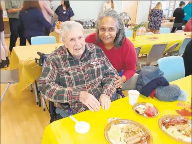  ?? Emily M. Olson / Hearst Connecticu­t Media ?? Ludwig “Luddy” Gauger and his caregiver, Yda Hock, attend the Community Health & Wellness Center’s annual Thanksgivi­ng breakfast on Thursday. Gauger has been a patient at the center for more than a decade.