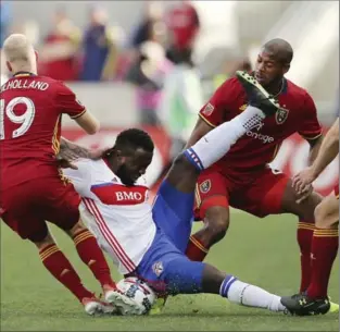  ?? SCOTT G WINTERTON, THE ASSOCIATED PRESS ?? Toronto FC forward Jozy Altidore falls to the pitch amid Real Salt Lake defenders during action last week in Sandy, Utah. The teams plays in Philadelph­ia on Saturday.