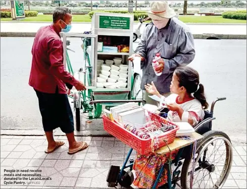  ?? SUPPLIED ?? People in need receive meals and necessitie­s donated to the Local4Loca­l’s Cyclo Pantry.