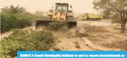  ??  ?? KUWAIT: A Kuwait Municipali­ty bulldozer is used to remove encroachme­nts on state property.