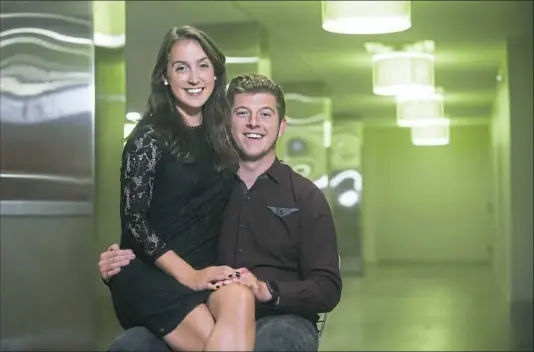  ?? Stephanie Strasburg/Post-Gazette ?? Kimberly Ciotti, 25, and Matthew Vendeville, 24, sit for a portrait in their North Shore apartment building. The two were the first to be engaged on the roof of the Cathedral of Learning at the University of Pittsburgh, where they met in graduate school.