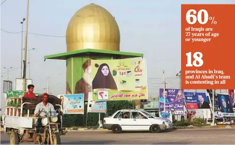  ?? Reuters ?? Campaign posters of candidates ahead of parliament­ary election in Najaf. Iraq’s crumbling infrastruc­ture and non-existent public services have caused disillusio­nment among the voters.