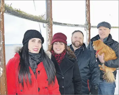  ?? JEREMY FRASER/CAPE BRETON POST ?? Members of the Low Point Lighthouse Society stand for a picture by the historic lighthouse lantern on Saturday. The society is working to have the lighthouse as part of a new Cape Breton tourism route. From left, are Danielle MacSween, Debbie Lee...