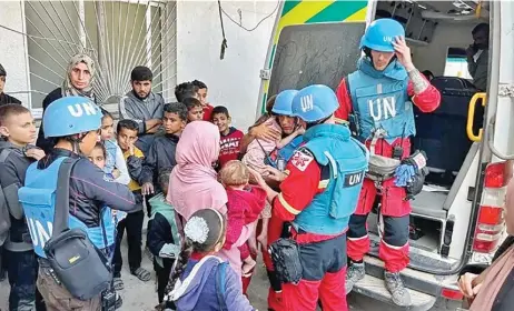  ?? ?? UNICEF team evacuates Palestinia­n children and women from Kamal Adwan Hospital who were not receiving adequate healthcare in Beit Lahia, Gaza, on Monday