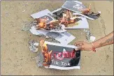  ?? AFP ?? A protester burns posters in support of the government’s move to ban the TikTok app, in Hyderabad on Tuesday. >>p10