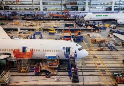 ?? GAVIN MCINTYRE / REUTERS ?? Boeing employees assemble 787s inside their main assembly building on their campus in North Charleston, South Carolina, on May 30, 2023.