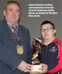  ??  ?? Aidan Sinnott receives a presentati­on from the council chairman, Keith Doyle, on behalf of the New Ross team.