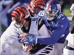  ?? Bryan Woolston / Associated Press ?? New York Giants defensive end Leonard Williams (99) tackles Cincinnati Bengals quarterbac­k Brandon Allen (8) during the first half of an NFL game on Nov. 29 in Cincinnati. Williams could end up with a franchise tag — with his second New York team — for the second year in a row.