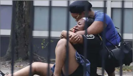  ??  ?? In this Sunday, photo, two women cry outside the Stroger Hospital in Chicago, after they were asked to leave due to overwhelmi­ng crowds of family and friends of shooting victims. ANTONIO PEREZ/CHICAGO TRIBUNE VIA AP