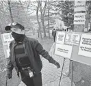  ?? ?? A security guard stands in front of Congregati­on Keter Torah in Teaneck on Sunday. At times, protesters on opposite sides of Roemer Avenue shouted at one another.