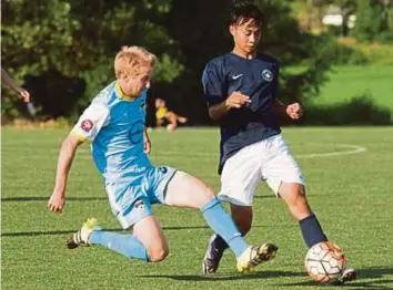  ??  ?? Wan Kuzain Wan Kamal (right) in action in a Premier Developmen­t League match last year.