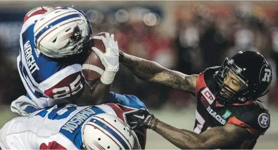  ?? DAVE SIDAWAY ?? Montreal Alouettes defensive back Dondre Wright intercepts a pass meant for Ottawa’s Vernon Johnson during Montreal’s 38-5 pre-season victory on Thursday.