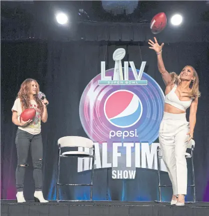  ??  ?? Jennifer Lopez, right, and Shakira during a press conference in Miami ahead of Super Bowl LIV.