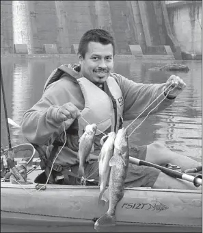  ?? Arkansas Democrat-Gazette/BRYAN HENDRICKS ?? Despite a slow bite, Abrahan Bahena of Hot Springs kept two white bass and a walleye Thursday on Lake Catherine below Carpenter Dam.