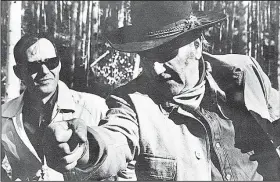  ??  ?? Charles Portis (left) is seen with John Wayne on the set of True Grit in 1968. (Special to the Arkansas Democrat-Gazette)