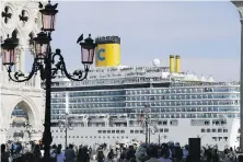  ?? LUCA BRUNO, AP ?? A cruise ship passes by St. Mark’s Square in Venice, Italy, in June of 2019. Italy is now banning mammoth cruise liners from sailing into the lagoon city, which risked within days of being declared an imperiled world heritage site by the United Nations.