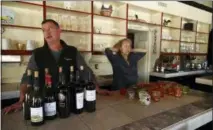  ?? BEN MARGOT — THE ASSOCIATED PRESS ?? All Seasons restaurant chef Kevin Kathman, left, and owner Gayle Keller stand at the bar as they look at their empty business Monday in Calistoga The restaurant was forced to close, losing an estimated $20,000 per day, as their power was cut off.