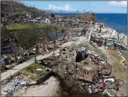  ?? (AP/Greenpeace/Erwin Mascarinas) ?? The debris from homes destroyed by Typhoon Rai lies Monday along a southern Philippine coastal village near Surigao City. Video at arkansason­line.com/1222rai/.