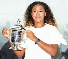  ??  ?? Naomi Osaka poses with the championsh­ip trophy at the Top of the Rock Observator­y the day after winning the Women’s Singles finals match against Serena Williams at the US Open in the Manhattan borough of New York City, US. — Reuters photo