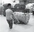  ?? VENETIAN RESORT LAS VEGAS ?? A staff member at the Venetian Resort in Las Vegas moves 644 pounds of masks.