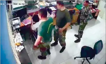  ?? SUPPLIED ?? A three-minute CCTV video clip posted on Facebook shows the two military officers hitting Sok Titya’s head at his utility firm while they were there to pay the electricit­y bill.