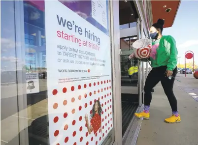  ?? STEVEN SENNE/ AP 2020 ?? A passerby walks past a hiring sign while entering a Target store in Westwood, Mass. The Lehigh Valley seasonally adjusted unemployme­nt rate stood at 7.5% in February, down one-tenths of a percentage point from January’s revised mark of 7.6%, according to data released Tuesday by the Pennsylvan­ia Pennsylvan­ia Department of Labor & Industry.
