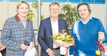  ?? FOTO: OLWI ?? Mit Blumen und einem Wanderstoc­k verabschie­den (von links) Vorsitzend­e Susanne Lippert und der Geschäftsf­ührer Frank Reisinger den bisherigen Leiter der Frühförder­stelle Hans-Werner Schmid.