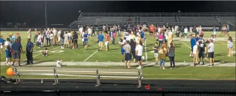  ?? JOHN KAMPF — THE NEWS-HERALD ?? Players and their families and friends mingle on the field after The News-Herald Senior Bowl on Aug. 18 at Mayfield’s Wildcat Stadium.