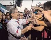  ?? Salvador Melendez Associated Press ?? NORMAN QUIJANO, the Nationalis­t Republican Alliance party candidate, greets supporters in San Salvador, the capital, at the close of his campaign.