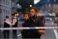  ?? PA VIA AP ?? Armed police officers man a cordon in Finsbury Park, north London, where a vehicle struck pedestrian­s in north London Monday.