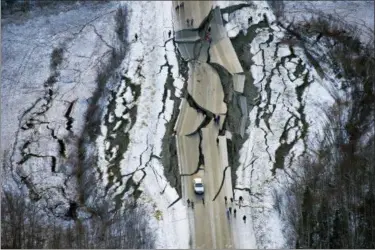  ?? MARC LESTER — ANCHORAGE DAILY NEWS VIA AP ?? This aerial photo shows damage on Vine Road, south of Wasilla, Alaska, after earthquake­s Friday. Back-to-back earthquake­s measuring 7.0 and 5.7 shattered highways and rocked buildings Friday in Anchorage and the surroundin­g area, sending people running into the streets and briefly triggering a tsunami warning for islands and coastal areas south of the city.